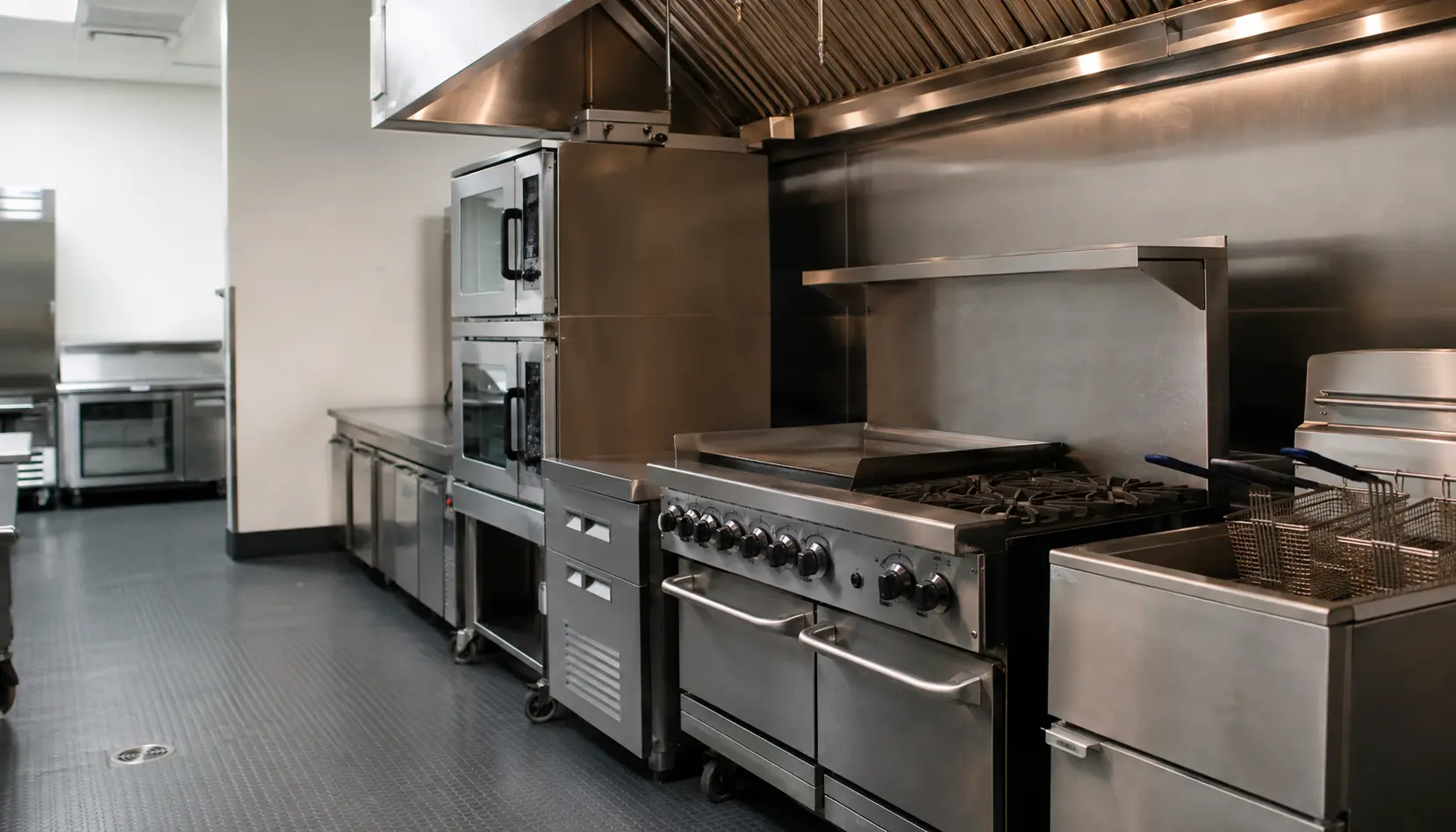 A commercial kitchen line of ranges, ovens and refrigeration