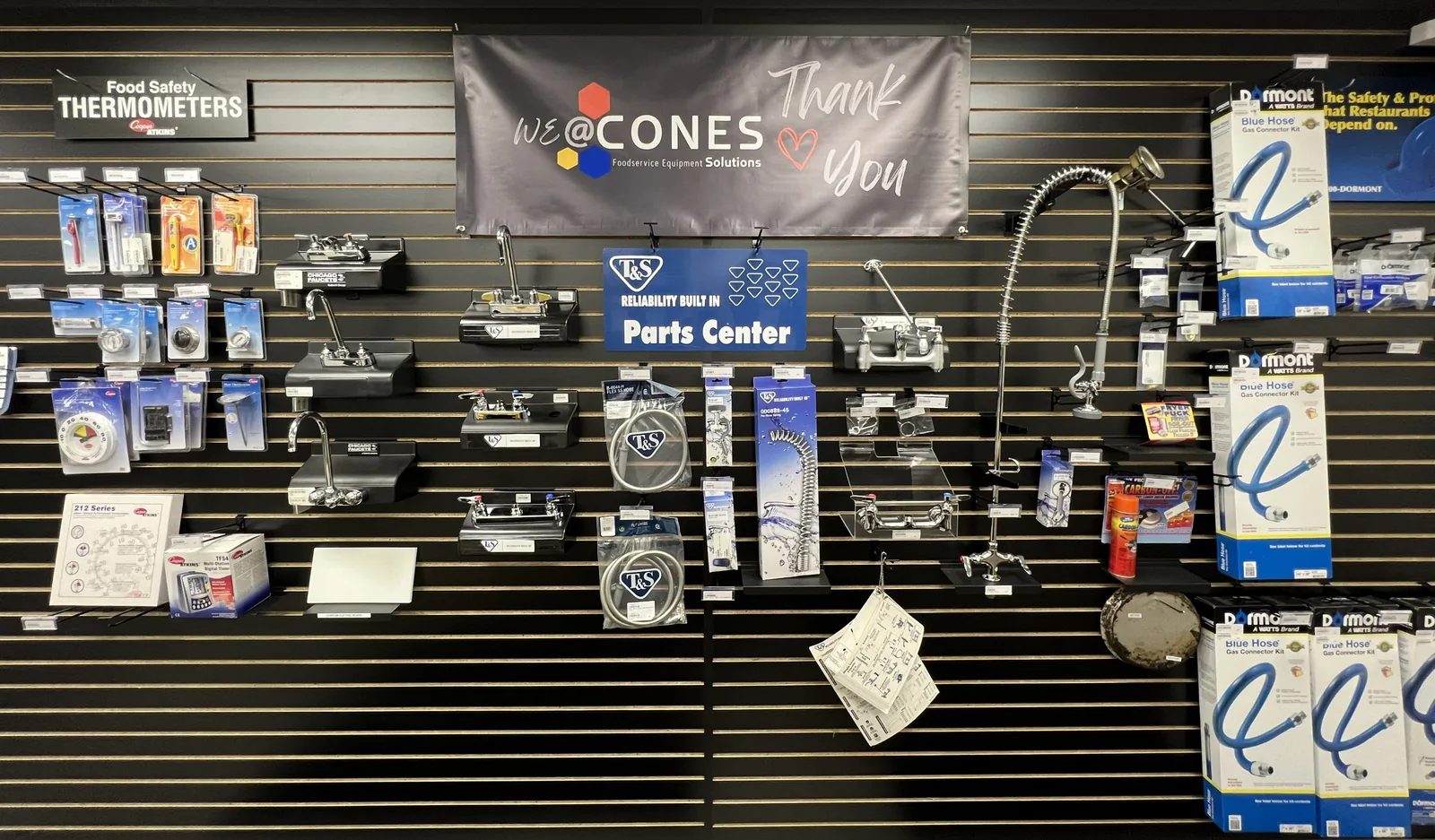 The T and S Brass parts wall at the CONES Solutions Moline counter, with faucets, pre-rinse units and gas connector kits